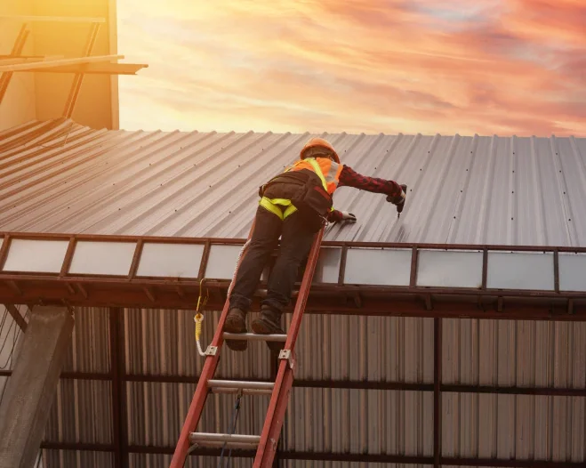 worker installing metal roof